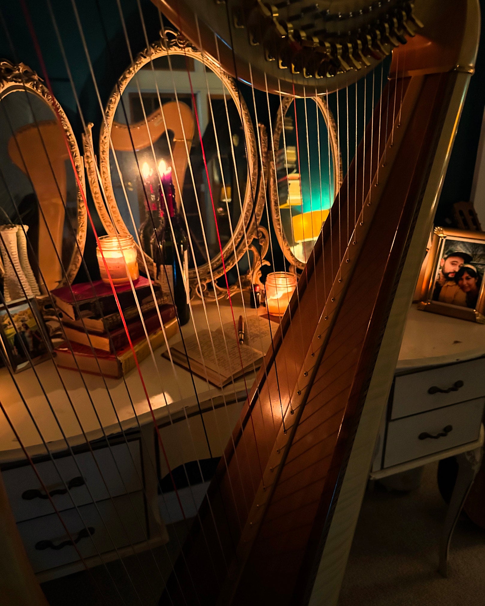 Candlelit desk with harp and mirrors