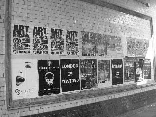 Tiled wall covered in gig posters and flyers, London
