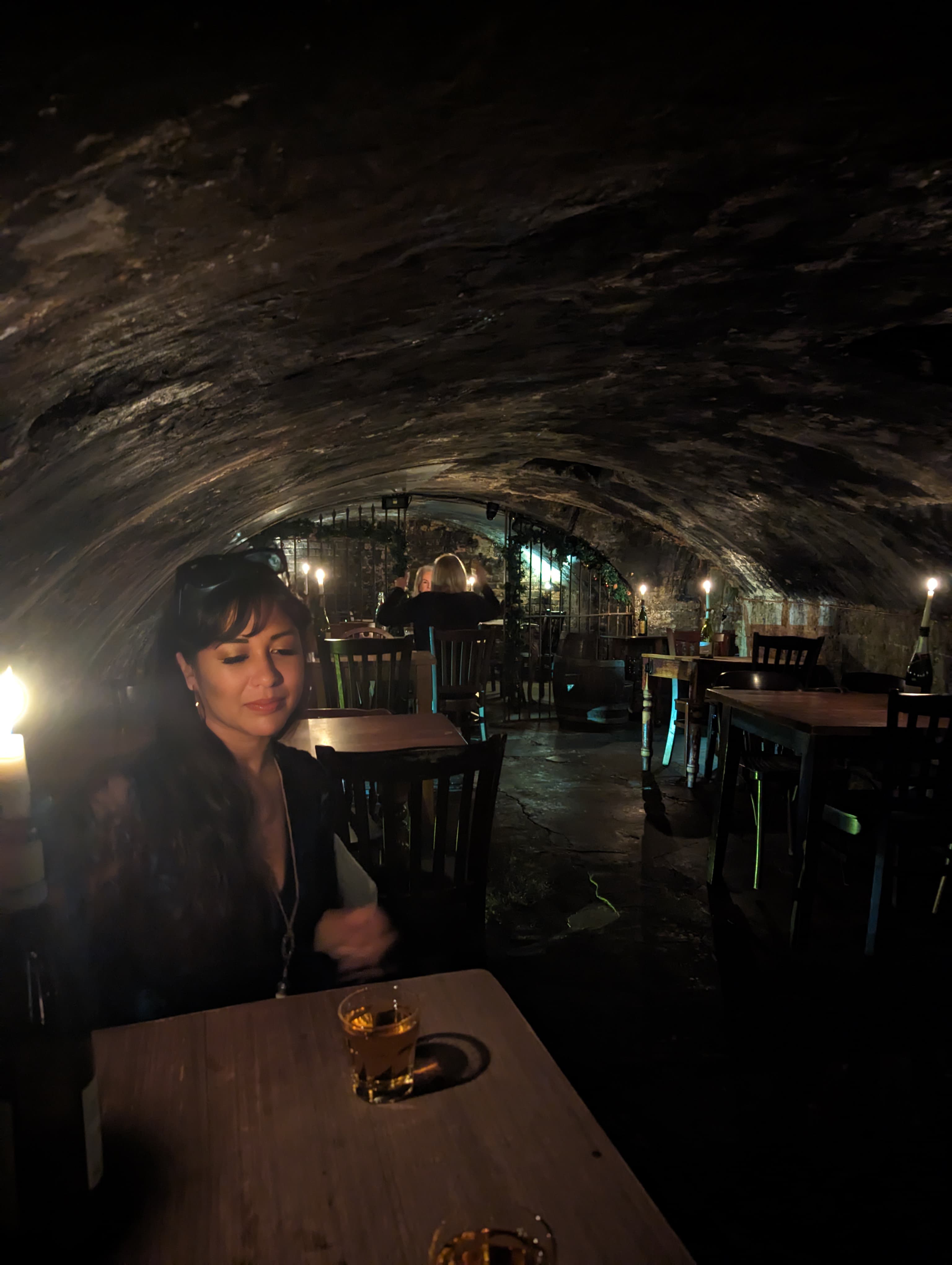 Low vaulted cellar bar, candles and empty tables